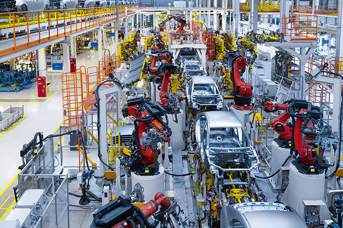 Robotic arms welding car bodies on a production line